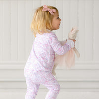 ballet snap onesie on baby playing with doll