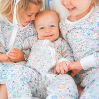 bunny garden zip onesie on baby with sisters