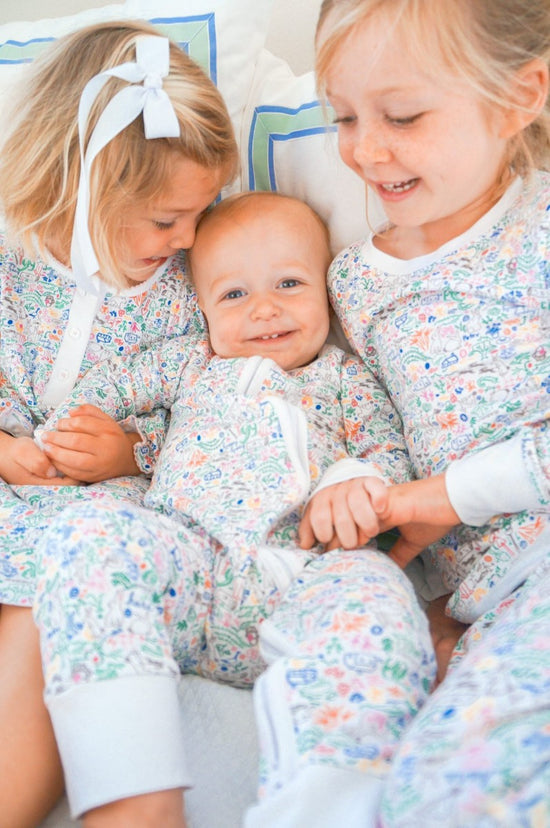 bunny garden zip onesie on baby with sisters