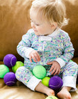 joy street baby zip onesie on baby with tennis balls