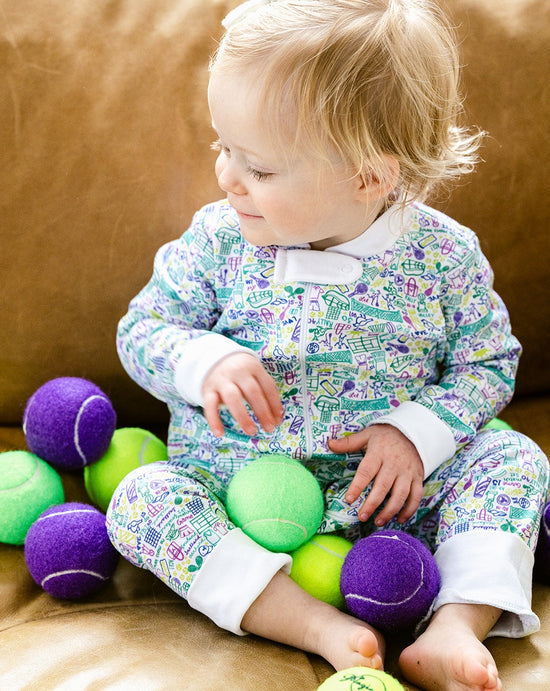 joy street baby zip onesie on baby with tennis balls
