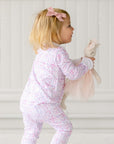 ballet snap onesie on baby playing with doll