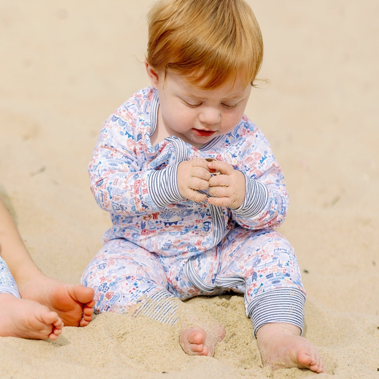 USA baby zip onesie on baby at the beach joy street